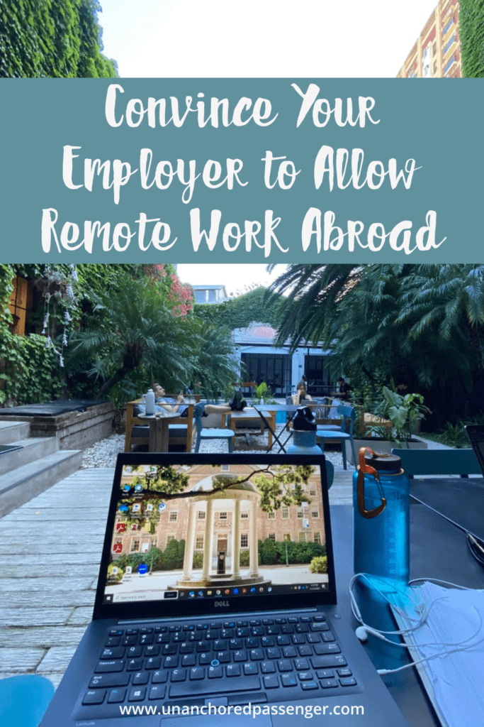 Laptop in a coworking space with palm trees and other green plants and people working in the background with text that says, "Convince Your Employer to Allow Remote Work Abroad"