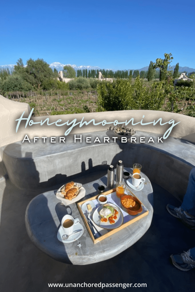 Breakfast with a view of vineyards and mountains and text that reads, "Honeymooning After Heartbreak"