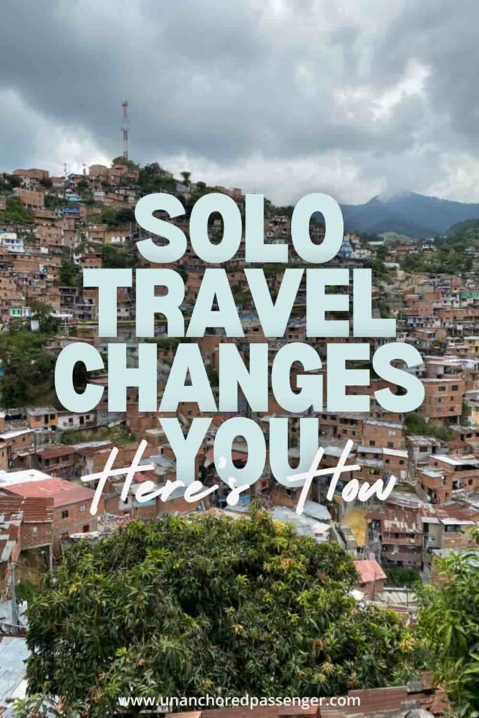 Houses in a mountain valley in Medellín, Colombia with text that says, "Solo travel changes you, here's how"