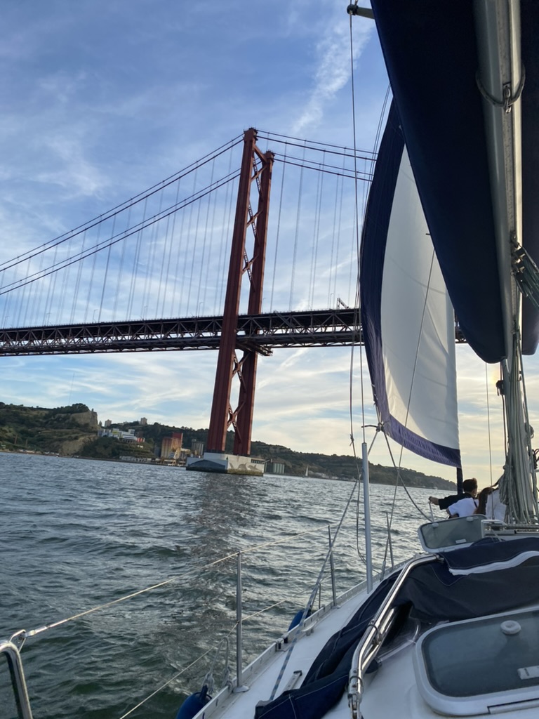 Sailing under the 25 de Abril Bridge in Lisbon, Portugal