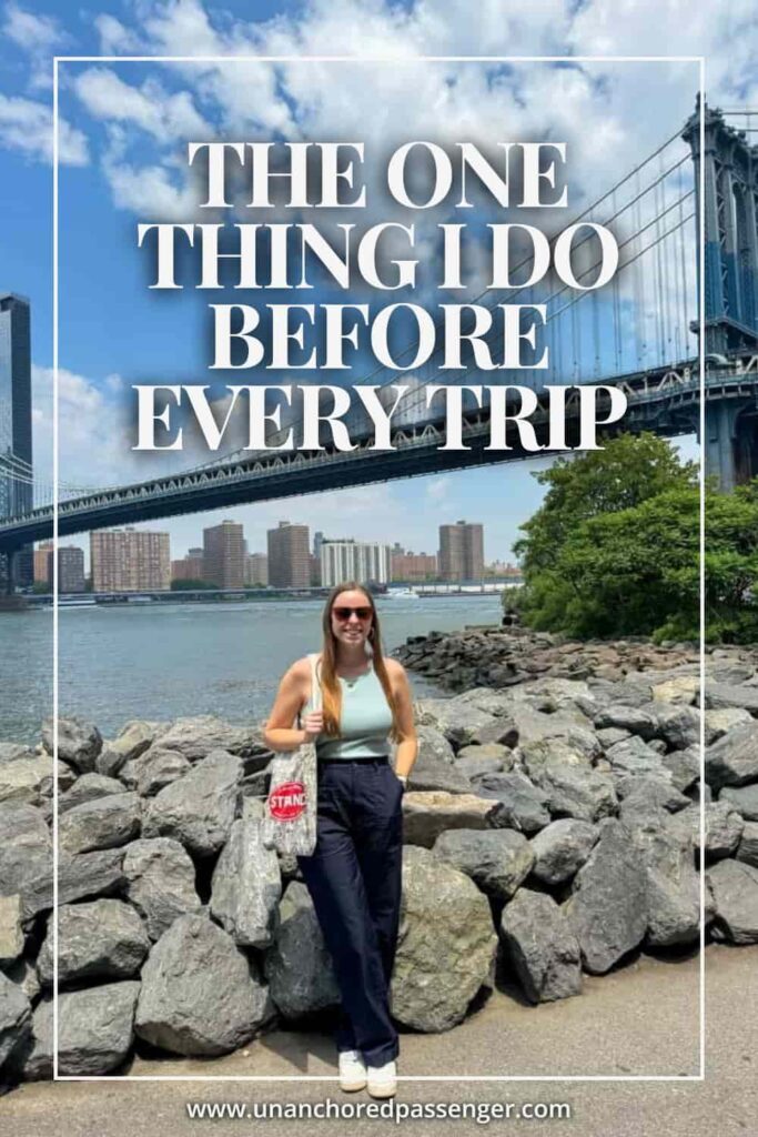 Woman smiling in front of the Manhattan Bridge in Brooklyn, New York with text that says, "The One Thing I Do Before Every Trip"