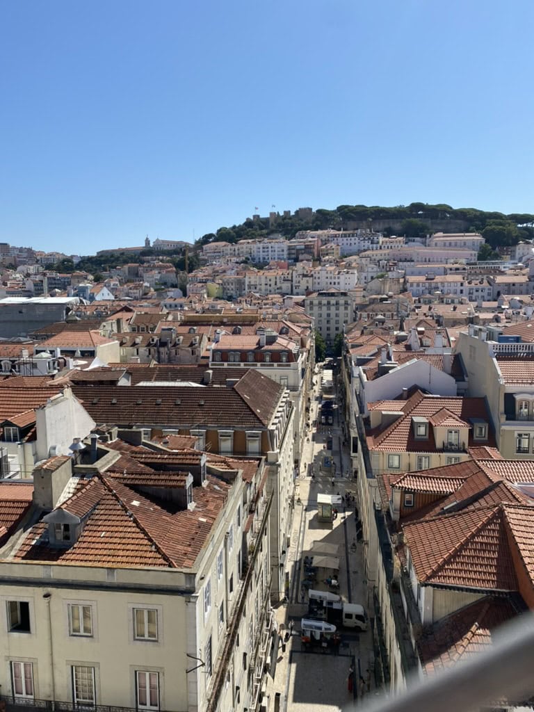 View of Lisbon, Portugal from above showing bright orange rooftops of all the buildings