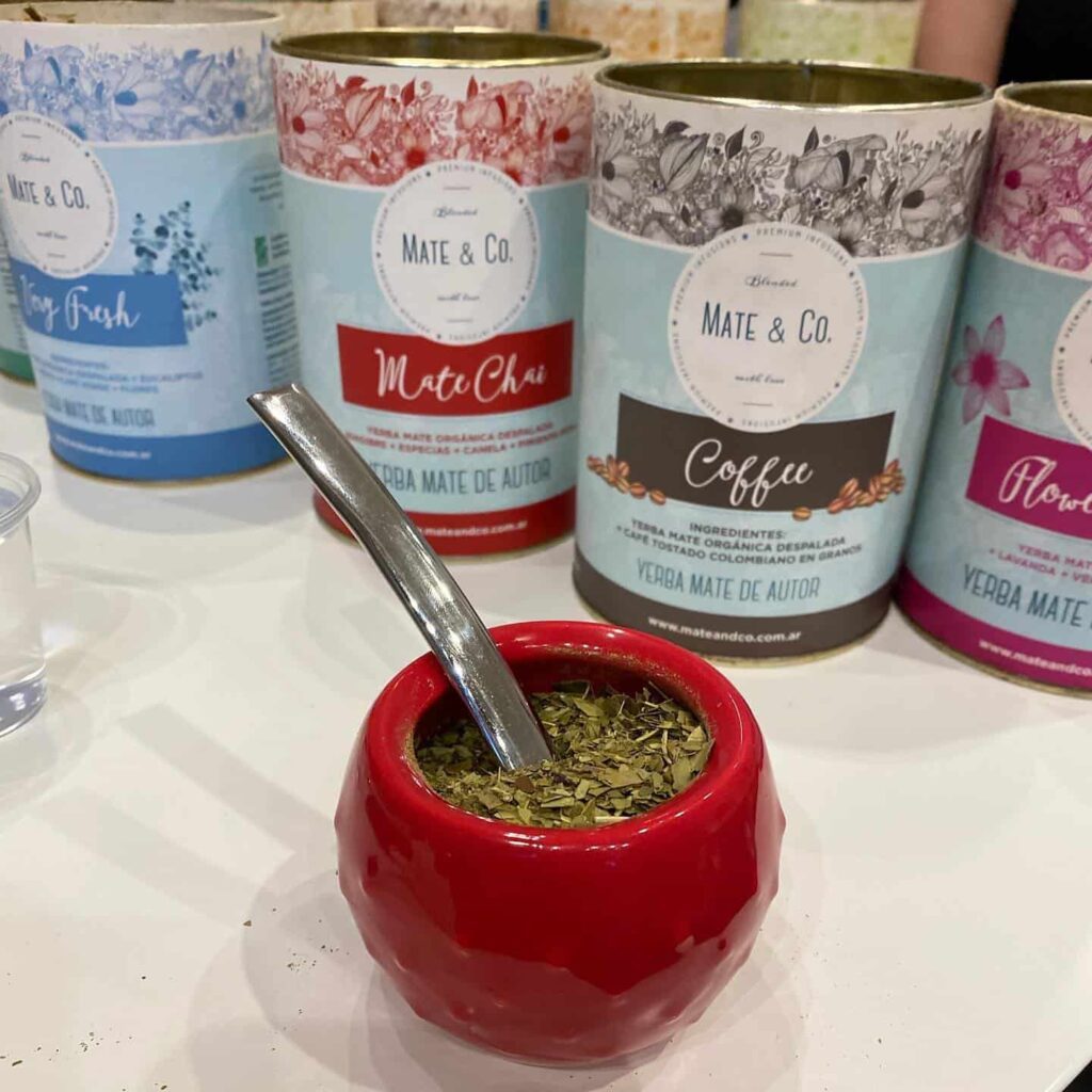 A mate tasting in Buenos Aires with different blends of mate tea and a mate cup filled with the leaves