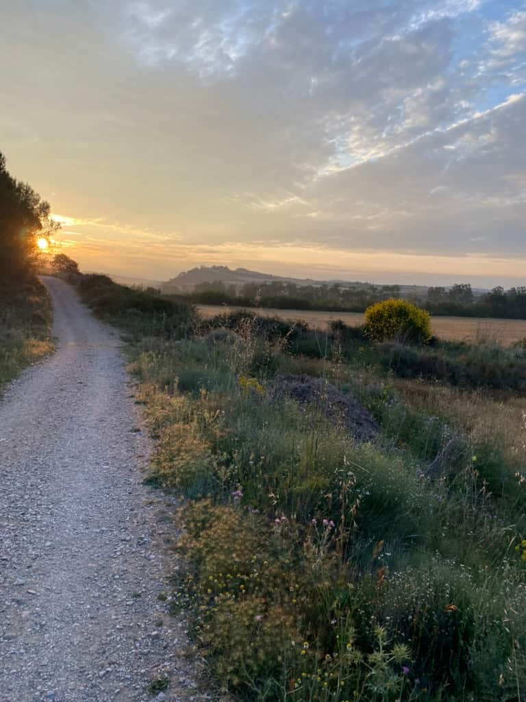 Sunrise over a hiking path on the Camino de Santiago.