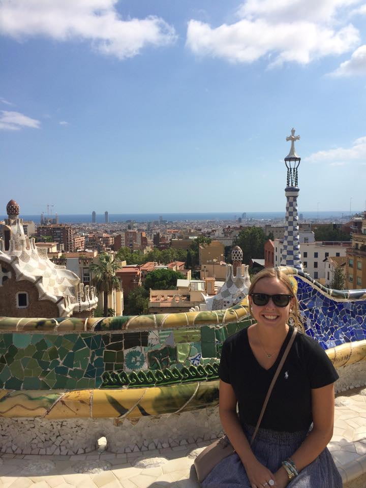 Woman sitting on a bench in Park Güell in Barcelona.