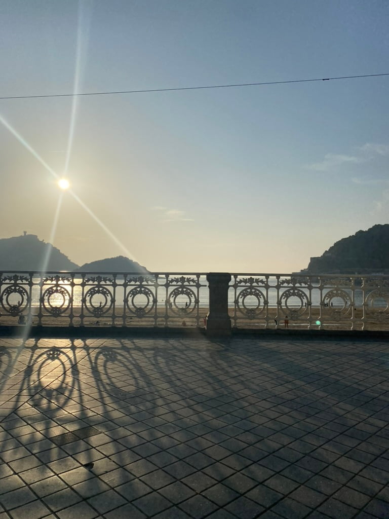 Beachside walkway at sunset in San Sebastián, Spain.