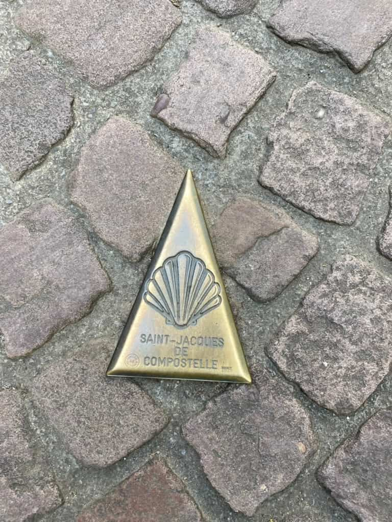 Camino de Santiago shell marker in the cobblestone street at the Porte de Saint-Jacques in Saint-Jean-Pied-de-Port.