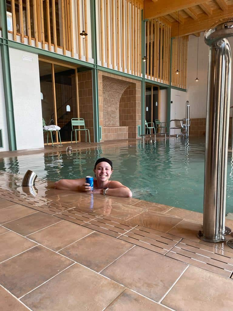 Woman smiling in a hydrotherapy spa at an albergue in Hontanas, Spain along the Camino Francés.